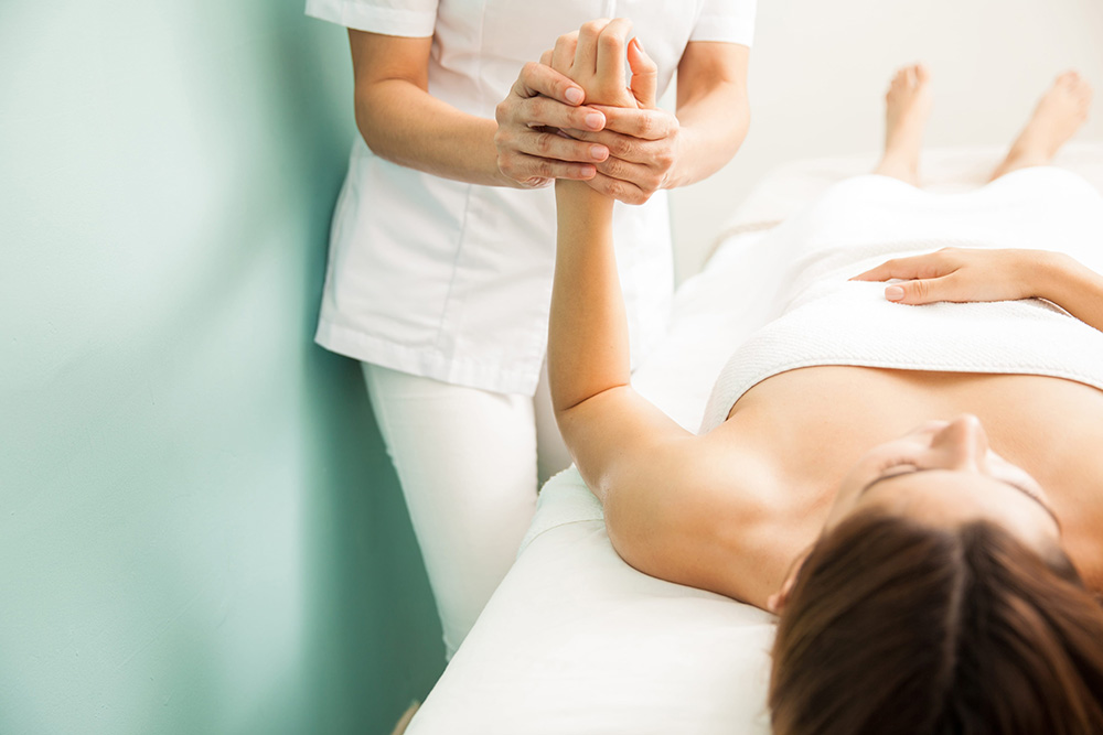 Young woman getting digitopuncture therapy at a health and beauty spa