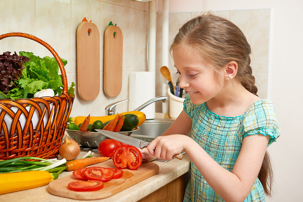 GIRL CHOPPING TOMATOES