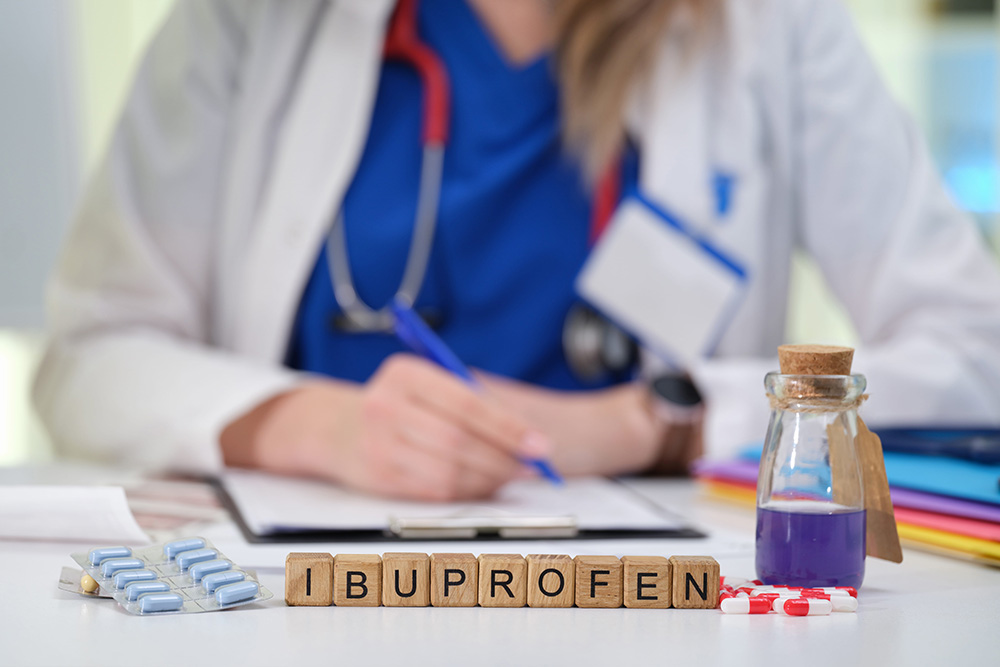 A Medical Professional with Ibuprofen and a Prescription Pad available for patient care